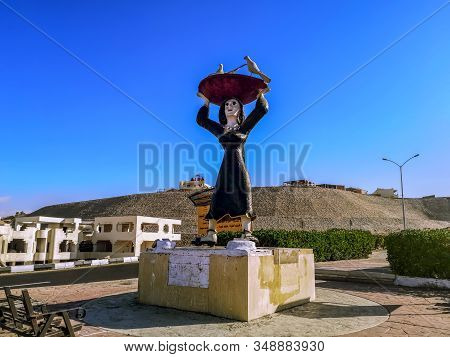 Egypt, Sharm El Sheikh - January 17, 2020: Statue Of An Arab Woman Holding A Large Dish With Birds O