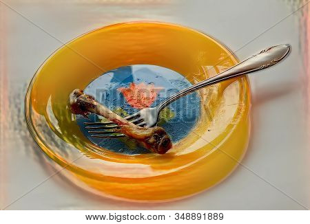 Crisis. Chicken Bone On A Plate After Meal