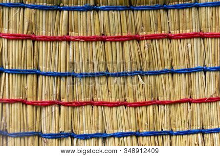 Texture Of Broom Bandaged With Red And Blue Ropes, Sorghum Stems Close Up, Texture Background. Illus