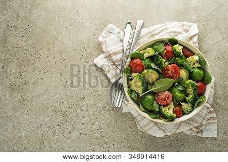 Healthy Green Salad With Fresh Cooked Vegetables On Grey Background