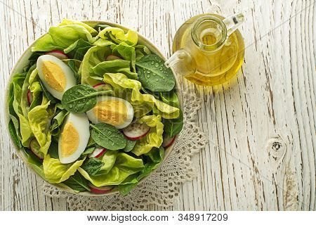 Healthy Green Salad With Eggs On Wooden Table Background. Healthy Meal.