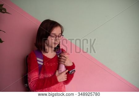 Girl With Cup. Schoolgirl Girl In Glasses Drinks Water From A Thermomug.a Schoolgirl Drinks Tea, Jui