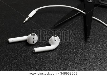 Air Pods. With Wireless Charging Case. New Airpods 2019 On Dark  Background. Airpods. Female Headpho