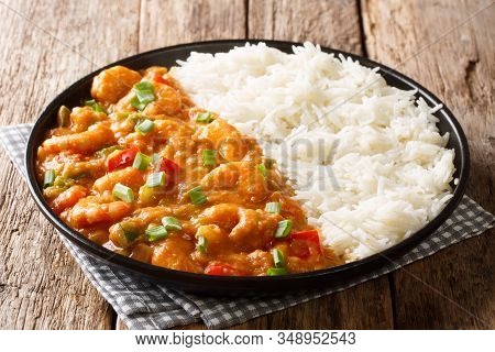 Serving Of Shrimp Etouffee With Vegetables And Sauce Served With Rice Closeup In A Plate. Horizontal
