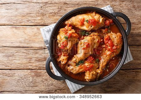 Tasty Spicy Rabbit Stew In Tomato Sauce With White Wine And Herbs Close-up In A Pan. Horizontal Top