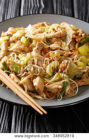 Delicious Filipino Food Pancit Bihon Rice Noodles With Vegetables And Meat Close-up In A Plate. Vert
