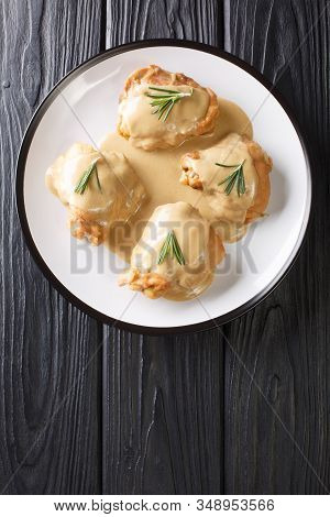 Chicken Thighs In A Sauce Of Dijon Mustard And Maple Syrup In A Plate Close-up. Vertical Top View