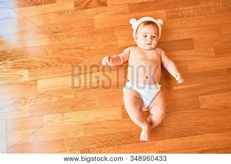 Adorable baby lying down on the sofa at home. Newborn wearing fanny hat relaxing and resting comfortable