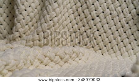 Close-up Of A White Knitted Blanket, Woolen Background.