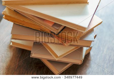 Set Of Books On A Wooden Table. Top View On Old Textbooks And Reference Books. Used Hardback Books. 