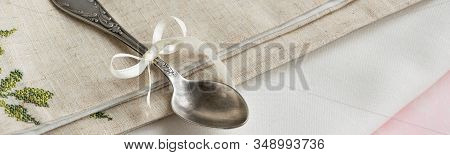 Vintage Russian Silverspoon With Silk Ribbon On Linen Napkin. Old Fashion Heroloom Silverware