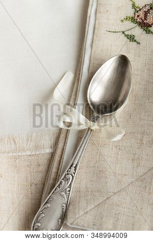 Vintage Russian Silverspoon With Silk Ribbon On Linen Napkin. Old Fashion Heroloom Silverware