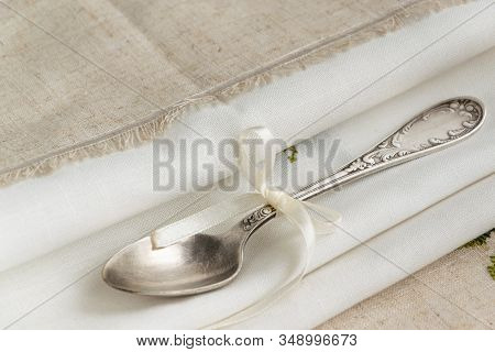 Vintage Russian Silverspoon With Silk Ribbon On Linen Napkin. Old Fashion Heroloom Silverware