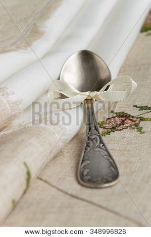 Vintage Russian Silverspoon With Silk Ribbon On Linen Napkin. Old Fashion Heroloom Silverware