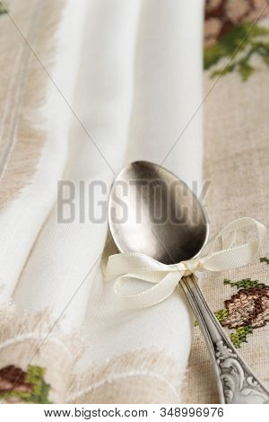 Vintage Russian Silverspoon With Silk Ribbon On Linen Napkin. Old Fashion Heroloom Silverware