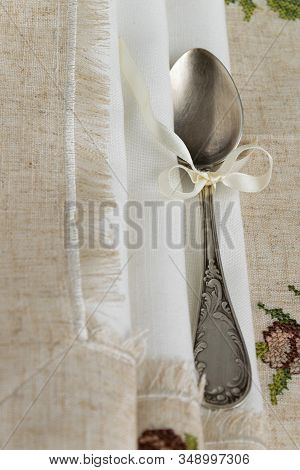Vintage Russian Silverspoon With Silk Ribbon On Linen Napkin. Old Fashion Heroloom Silverware