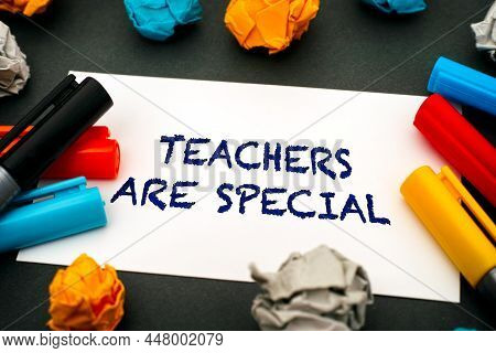 Paper With Words Teachers Are Special, Colour Pens And Crumpled Paper On Gark Green Background. Clos