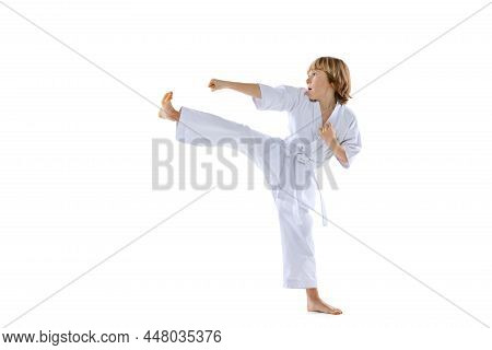 One Sportive Little Boys, Taekwondo Athletes Wearing Doboks Practicing Alone Isolated On White Backg