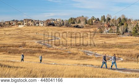 Fort Collins, CO, USA - January 30, 2022: Families enjoying a  warm calm winter afternoon on a biking trail at Cathy Fromme Prairie Natural Area in Colorado foothills.