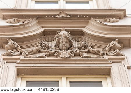 Bas-relief Above The Window. Bas-relief In The Form Of A Head On One Of The Houses Of Brno