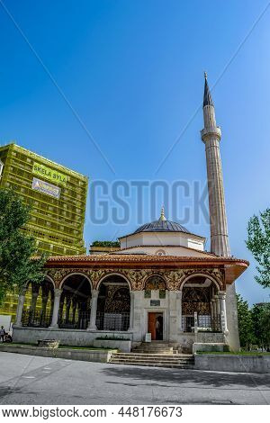Tirana, Albania - June 21, 2021:  Ethem Bey Mosque Near A Multi-storey New Building In Tirana, Verti