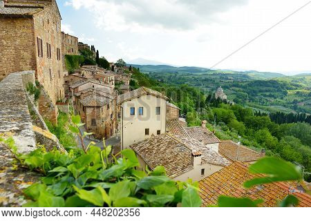 Green Hills And Pastures Of Tuscany And Rooftops Of Montepulciano Town, Located On Top Of A Limeston