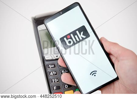 Wroclaw, Poland - Nov 06, 2019: Man Holding Smartphone With Blik Logo, Contactless Payment. Blik Is 