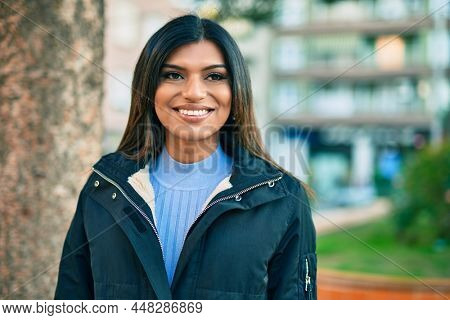 Beautiful hispanic woman smiling confient at the city