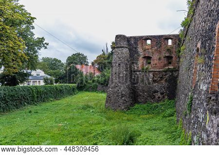Medieval Gray Castle Wall Of Ancient Uzhgorod Castle With A Green Lawn In Front. Uzhgorod Castle, Za