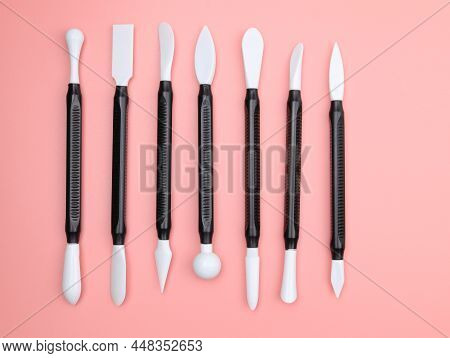 Plastic Tools For Sculpting Top View. Set Of Modern Pottery Tools On A Pink Background. Set Of Stack