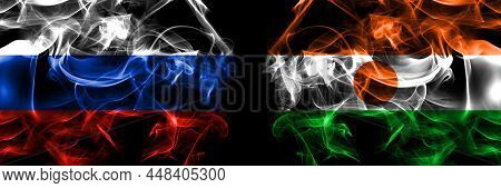 Russia, Russian Vs Niger, Nigerien Flags. Smoke Flag Placed Side By Side Isolated On Black Backgroun