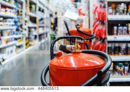 Large Fire Extinguishers In A Shopping Center Against The Backdrop Of Showcases With Goods. Fire Saf