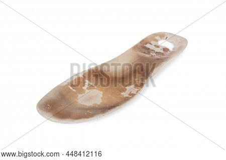 Old And Shabby Orthopedic Insoles Isolated On White Background. Dirty Leather Insoles. Worn Out Thin