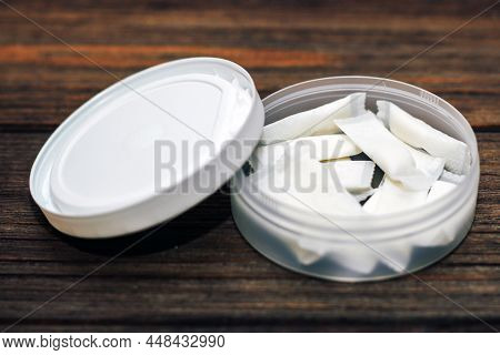 Snus Box With Nicotine Pouches On Wooden Background.