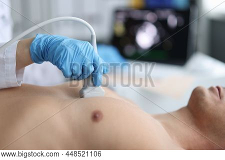 Doctor Performs Chest Ultrasound On Man In Hospital Room. Examination Of The Heart And Vessels Conce
