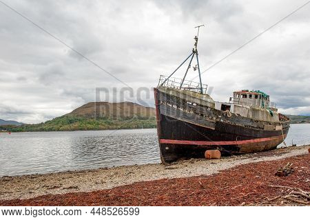 The Old Fishing Boat On The Shingled Shoreline Of Loch Linnhe Near Fort William , Scotland Higland, 