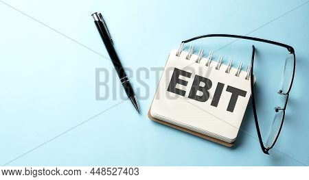 Ebit Text Written On Notepad On The Blue Background