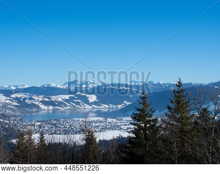 Bautiful Winter Landscape In Switzerland: View Towards Lake Aegeri With Surrounding Snow-covered Hil