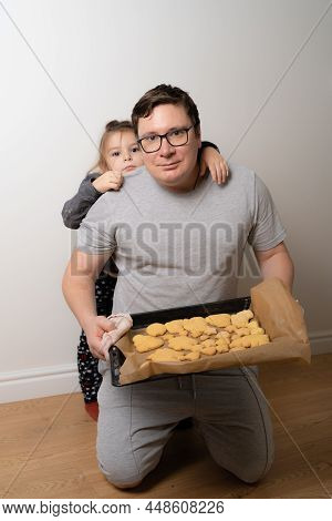 Father Feeling Playful With His Caucasian Little Daughter, While Preparing Homemade Christmas Tasty 