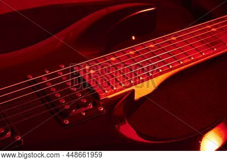 Black Electric Guitar Illuminated With Red Light