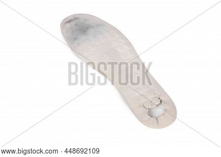 Old And Shabby Orthopedic Insoles Isolated On White Background. Dirty Leather Insoles. Worn Out Thin
