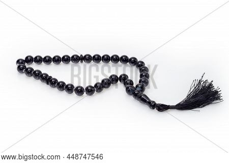 Black Prayer Beads With Balls Made Of The Stone, Side View On A White Background Close-up
