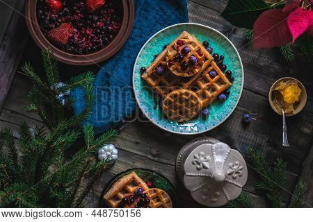 Croissant Waffle Or Croffle With Srawberry And Blueberry Sauce Served In Plate And Dark Background. 
