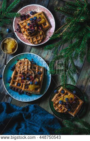 Croissant Waffle Or Croffle With Srawberry And Blueberry Sauce Served In Plate And Dark Background. 