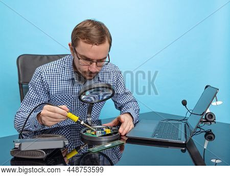 Potrait Of Professional Programmer, Technical Specialist Working With Motherboard Isolated Over Blue