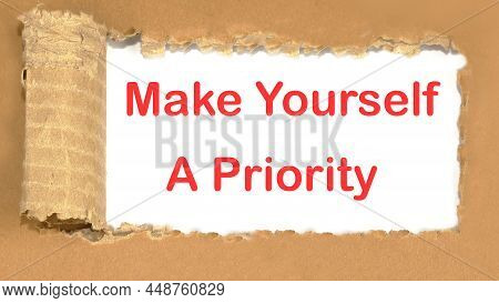 Make Yourself A Priority The Inscription Appearing Behind The Torn Cardboard Paper.
