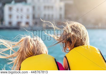 Back View Two Cute Little Blond Happy Excited Smiling Caucasian Girl Friends Wear Lifevest Enjoy Sai