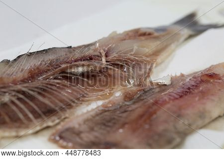 Meat And Bones Of Fresh Herring For A Delicious Dish, Carve Fish