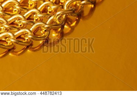 Golden Chain. Detail Of A Yellow Iron Chain. Metal Chain Link On The Gold Background. Decorative Jew