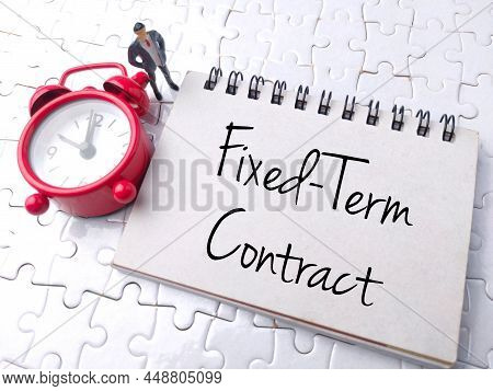 Top View Clock And Miniature People With Text Fixed-term Contract On A White Puzzle Background